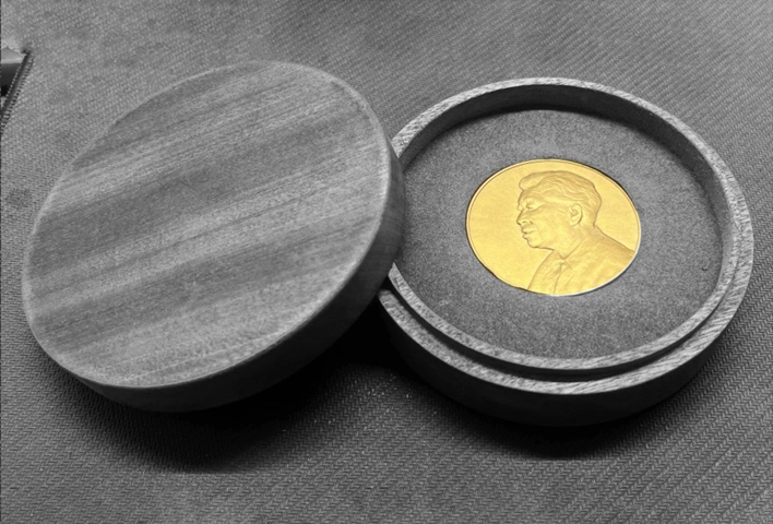 A custom 3D bronze relief portrait keepsake housed in a premium wooden box