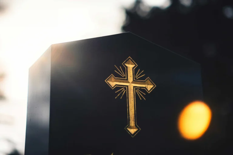 A close-up of a dignified cross engraving on a memorial urn, representing personalization and remembrance