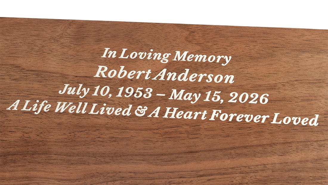 Pure Solid Walnut Urn for Ashes by Royal Memorials, showing a close-up detail of custom personalized engraving