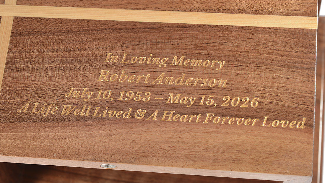 Two-Tone Inlay Walnut Cremation Urn for Ashes by Royal Memorials, showing a close-up detail of custom personalized engraving