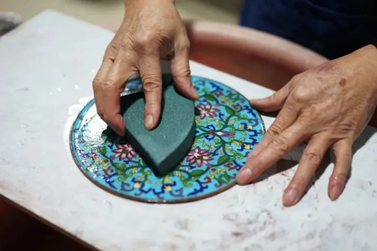 The grinding step in the hand-crafting process of a Cloisonne enamel keepsake urn