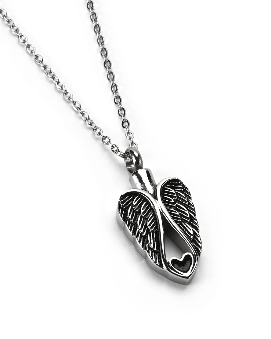 Angel Wings Heart Cremation Necklace for Ashes Angled view of angel wings heart cremation necklace for ashes in polished stainless steel with antiqued finish