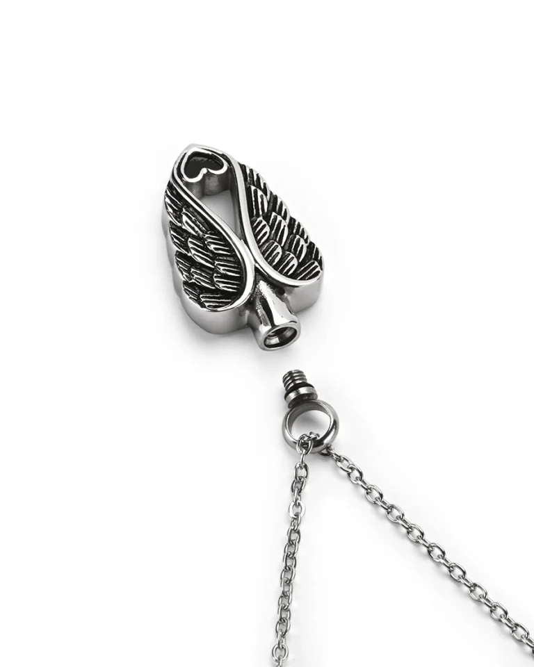 Top view showing unscrewed top bail with rubber gasket seal and inner chamber of angel wings heart cremation necklace