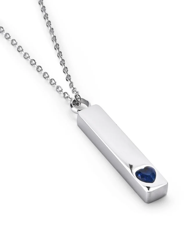 Angled view of Blue Crystal Heart Bar Cremation Necklace for Ashes featuring a raised blue heart crystal accent