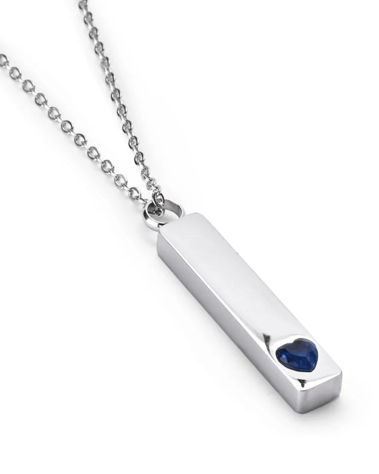 Angled view of Blue Crystal Heart Bar Cremation Necklace for Ashes featuring a raised blue heart crystal accent