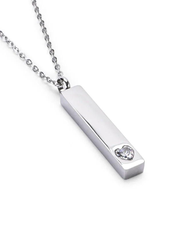 Angled view of Clear Crystal Heart Bar Cremation Necklace for Ashes featuring a raised clear heart crystal accent