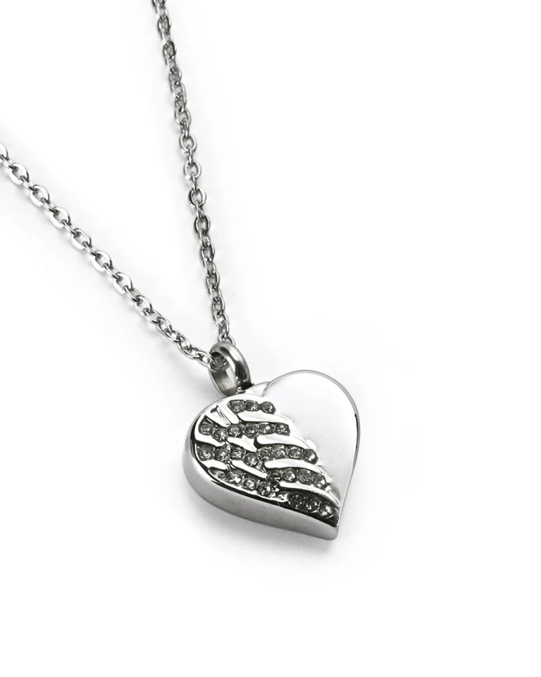 Angled view of crystal angel wing heart cremation necklace for ashes in polished stainless steel