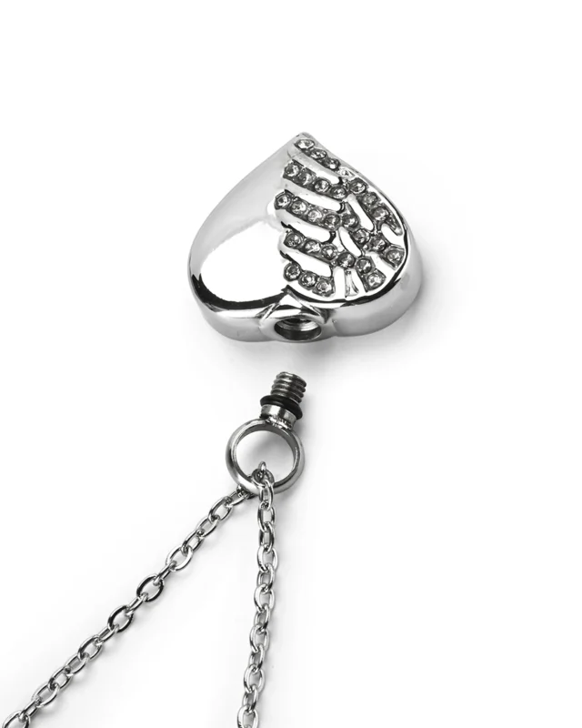 Top view showing unscrewed top bail with rubber gasket seal and inner chamber of crystal heart cremation necklace