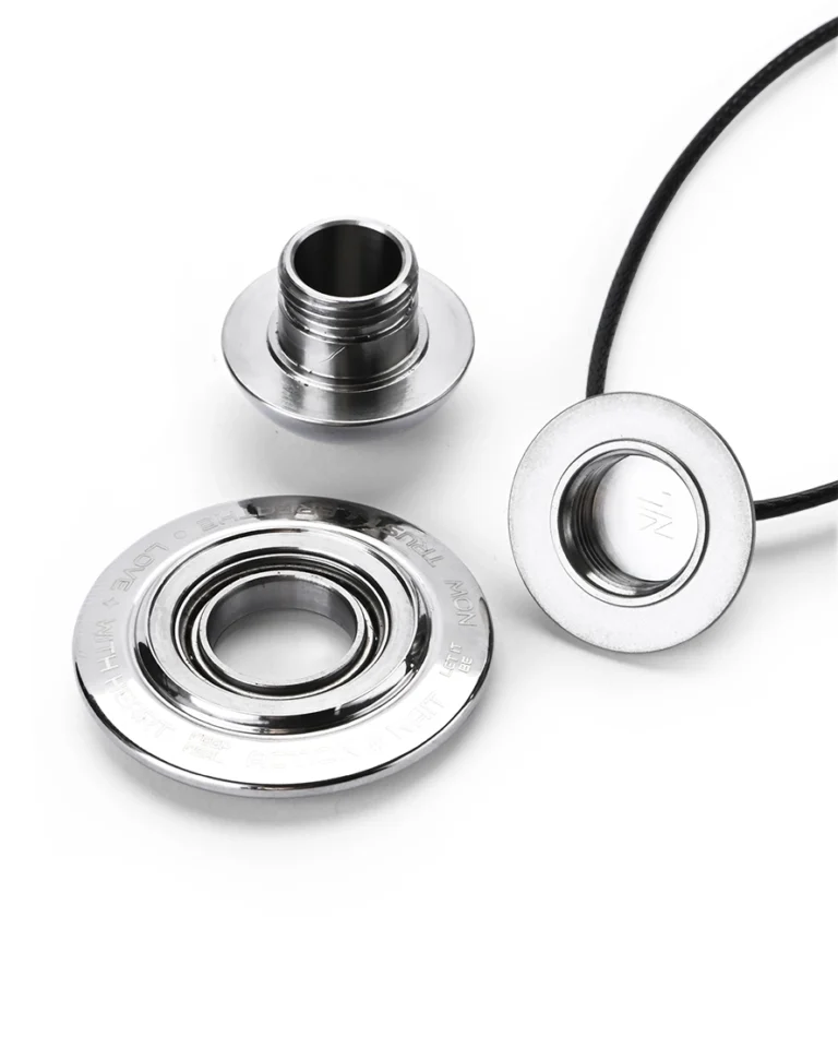 Disassembled polished titanium cremation necklace showing the threaded waterproof memory chamber and smooth ball bearing