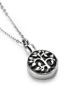 Angled view of tree of life circle cremation necklace for ashes in polished stainless steel