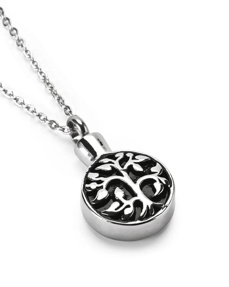 Angled view of tree of life circle cremation necklace for ashes in polished stainless steel