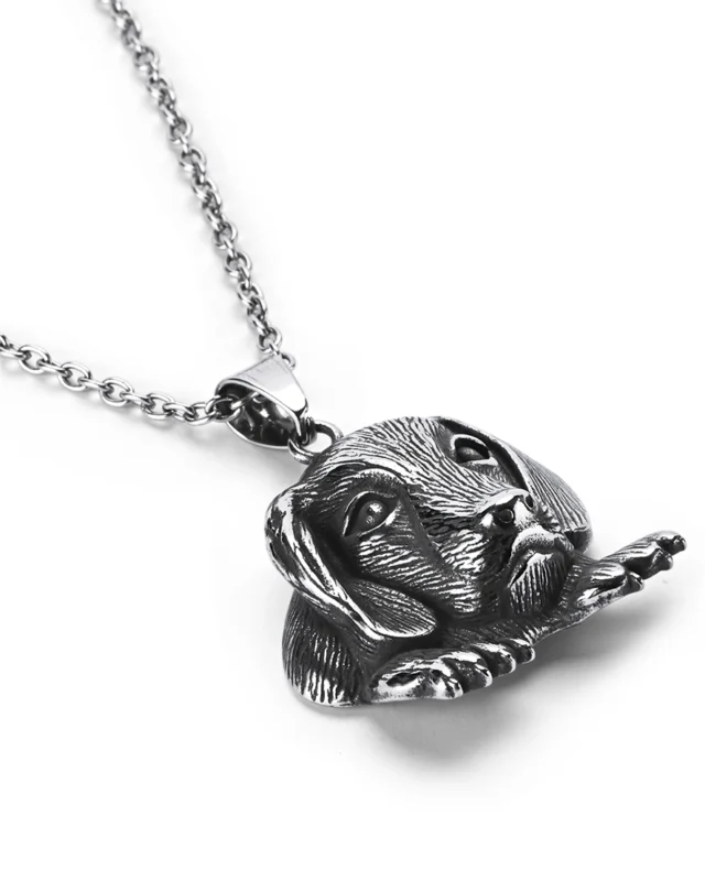 Angled view of dog stainless steel pendant highlighting three-dimensional fur textures and paws