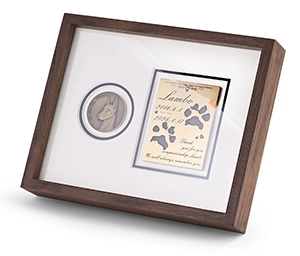 A solid walnut pet memorial display frame featuring a custom 3D brass relief portrait and engraved keepsake plaque by Royal Memorials