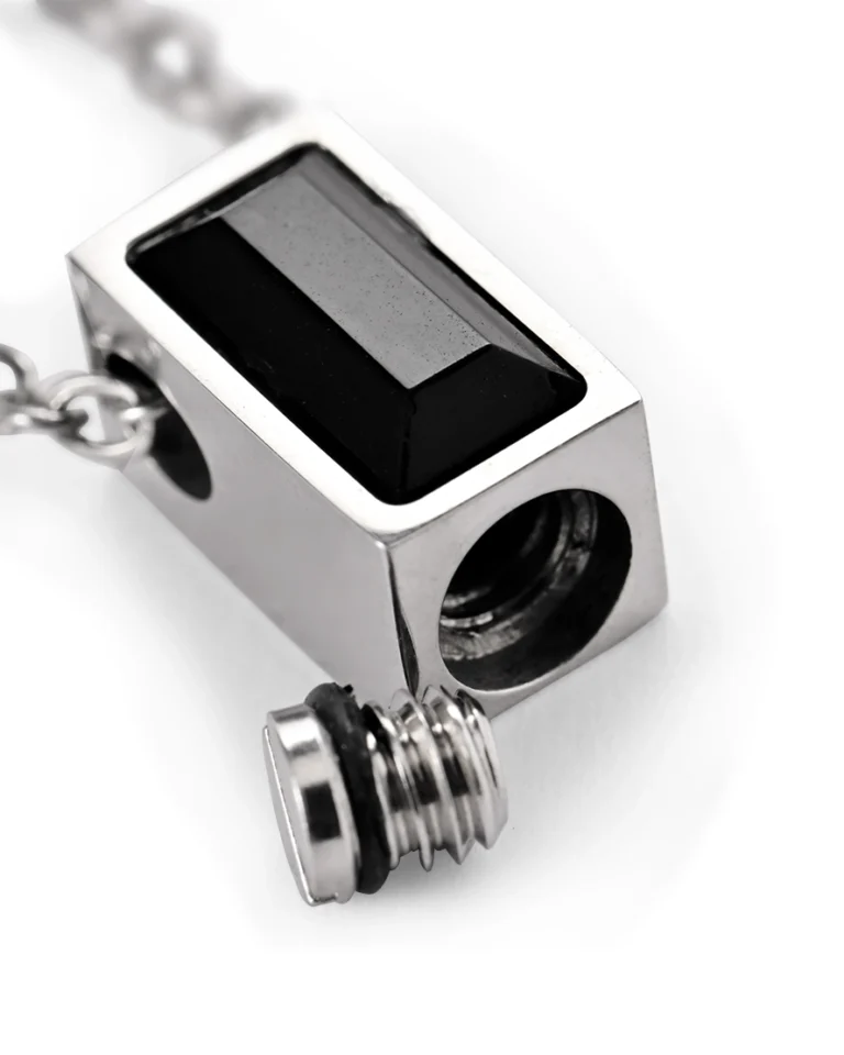 Bottom screw opening and rubber gasket on black rectangle urn necklace for ashes