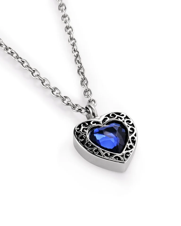 Blue heart urn necklace for ashes with faceted blue center, ornamental border and 20 inch stainless steel chain