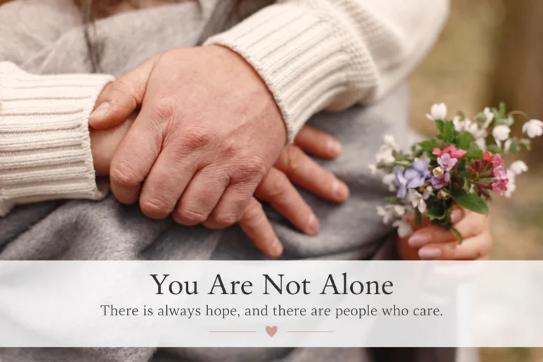 Two people holding hands beside flowers. Text reads: “You Are Not Alone. There is always hope, and there are people who care
