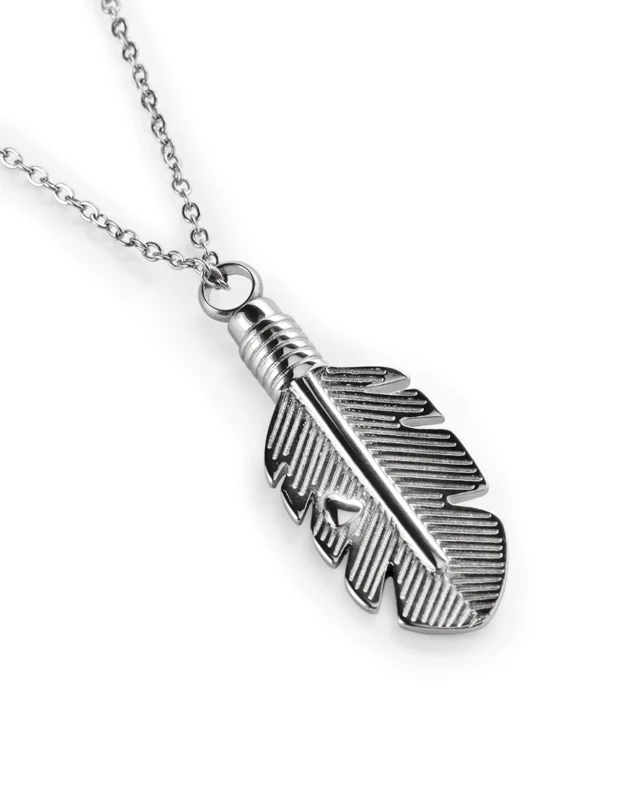 Angled view of stainless steel feather cremation necklace showing recessed line detailing