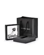 Feathered heart urn necklace displayed in a presentation frame with gift packaging