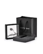 Floral teardrop urn necklace displayed in a presentation frame with gift packaging
