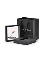 Gold-tone clear rectangle urn necklace displayed in a presentation frame with gift packaging