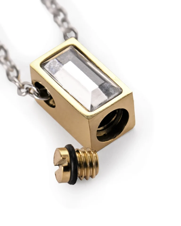 Bottom screw opening and rubber gasket on gold-tone rectangle urn necklace for ashes