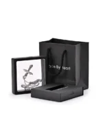 Silver Angel Wings Cross urn necklace displayed in a presentation frame with gift packaging