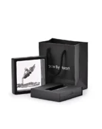 Winged heart urn necklace displayed in a presentation frame with gift packaging