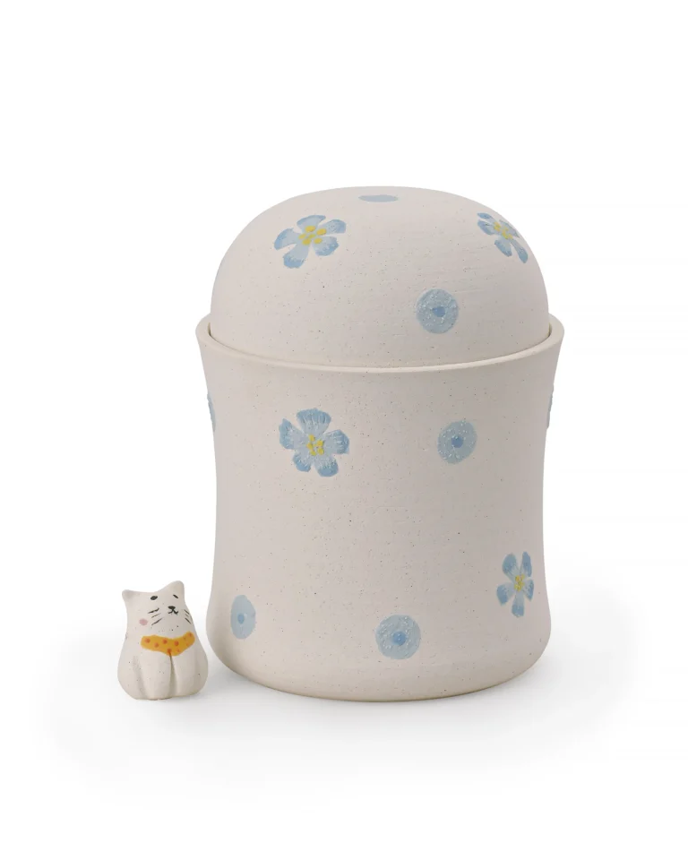 Blue floral ceramic pet urn with a textured off-white surface, hand-painted flowers, dome-shaped lid, and separate cat figurine