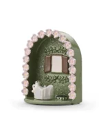 Angled view of green Floral Window pet memorial shrine showing pink floral border, window-style photo area, and LED candle