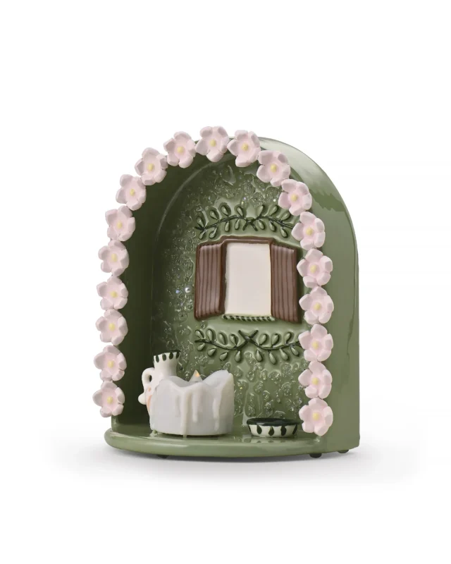 Angled view of green Floral Window pet memorial shrine showing pink floral border, window-style photo area, and LED candle