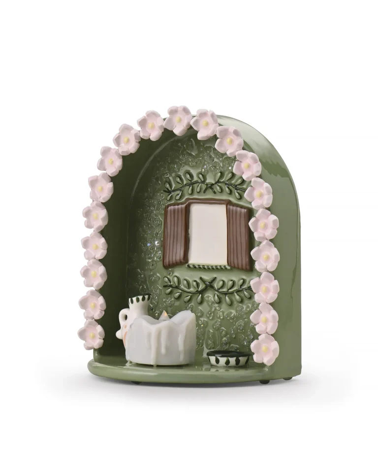 Angled view of green Floral Window pet memorial shrine showing pink floral border, window-style photo area, and LED candle