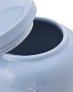Close-up of light blue ceramic pet urn showing the removable lid, fitted sealing ring, and top opening