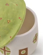 Close-up of the green floral roof lid and top opening of the ceramic mushroom house pet urn