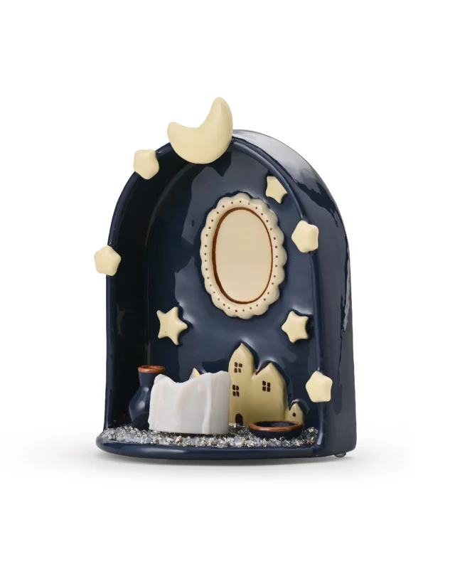 Angled view of Moon & Stars pet memorial shrine showing the curved ABS body, miniature houses, and LED candle