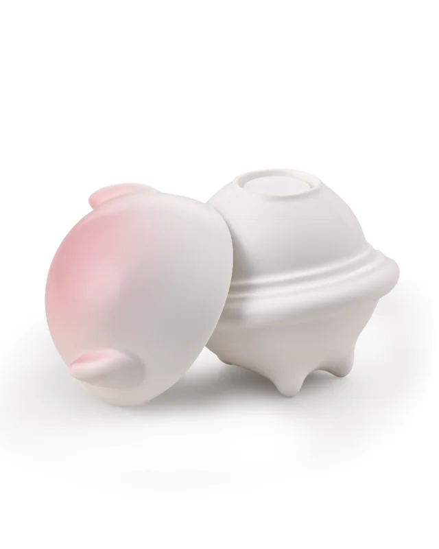 Pink and white ceramic pet urn with the outer cover removed to show the separate inner lid