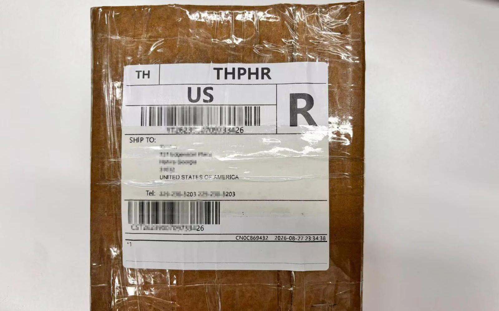 A sealed cardboard package with a shipping label prepared for a Royal Memorials customer