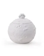Round white ceramic pet urn with moon-like circular surface texture and a paw-shaped handle on the removable dome lid
